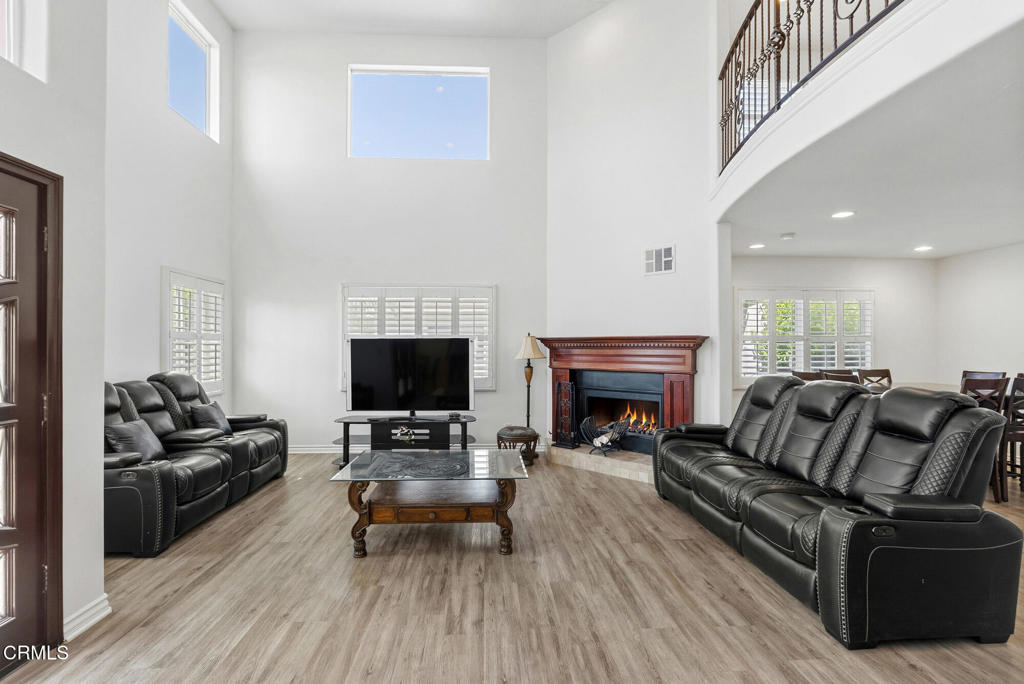 2546 Commerce Way Commerce, CA 90040 - Photo 3 of 53 a living room with furniture a fireplace and a flat screen tv