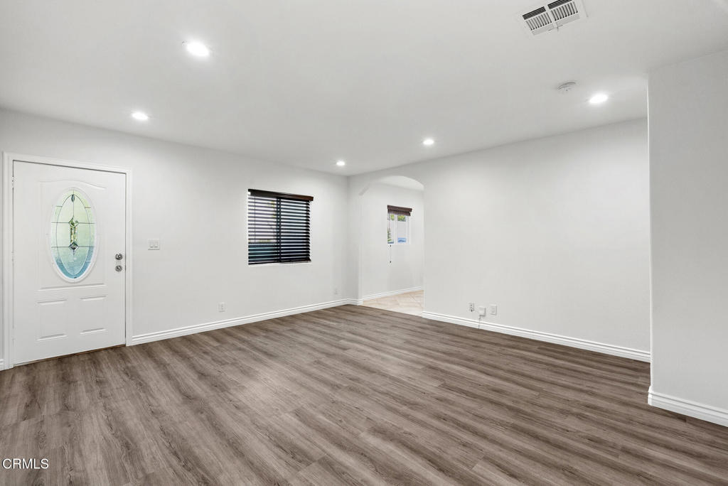 2546 Commerce Way Commerce, CA 90040 - Photo 35 of 53 an empty room with wooden floor and windows