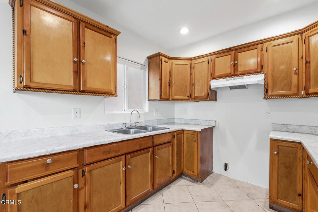 2546 Commerce Way Commerce, CA 90040 - Photo 37 of 53 a kitchen with stainless steel appliances granite countertop a sink and cabinets