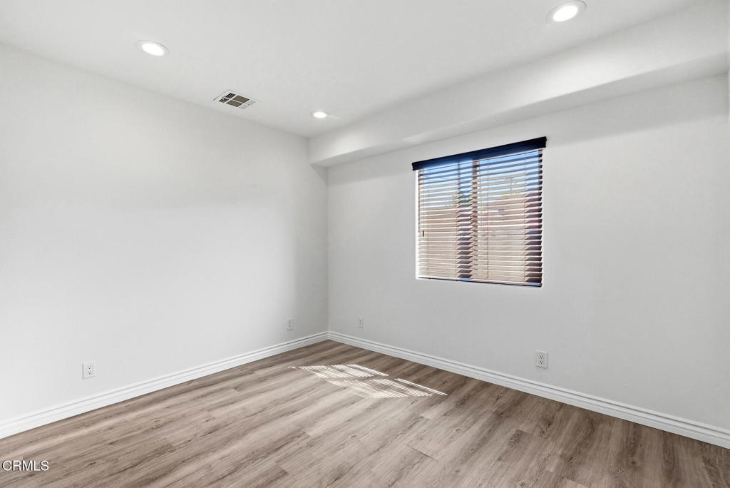2546 Commerce Way Commerce, CA 90040 - Photo 39 of 53 an empty room with wooden floor and a window