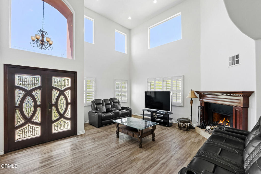 2546 Commerce Way Commerce, CA 90040 - Photo 4 of 53 a living room with furniture a fireplace and a flat screen tv