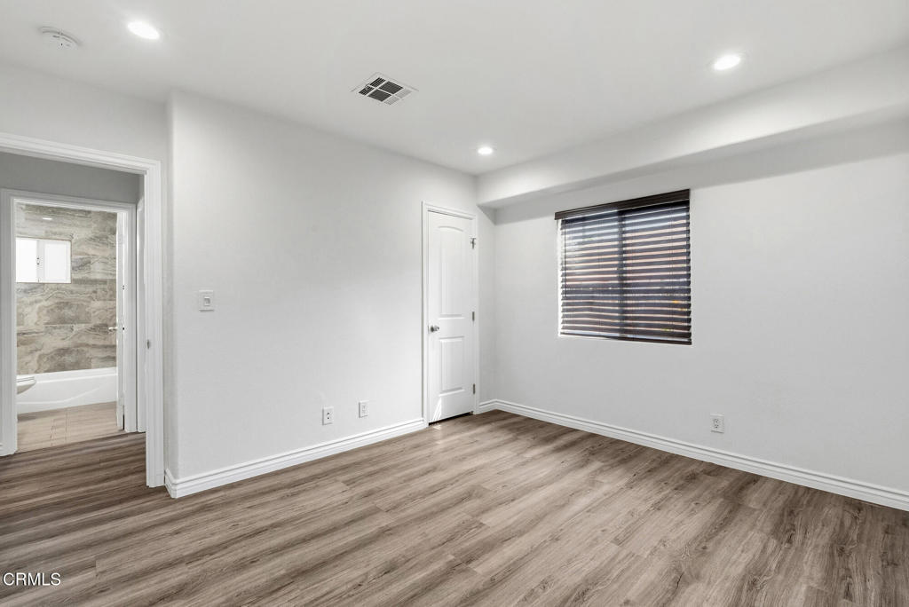 2546 Commerce Way Commerce, CA 90040 - Photo 42 of 53 wooden floor in an empty room with a window