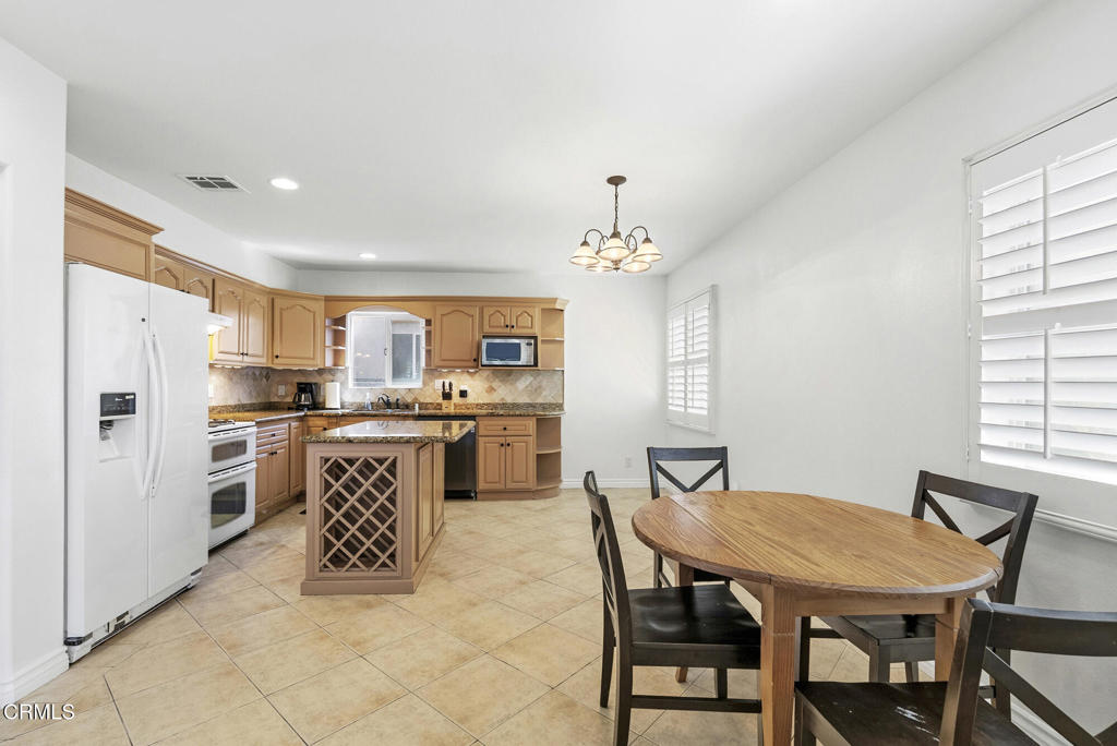 2546 Commerce Way Commerce, CA 90040 - Photo 6 of 53 a view of a dining room with furniture and a chandelier