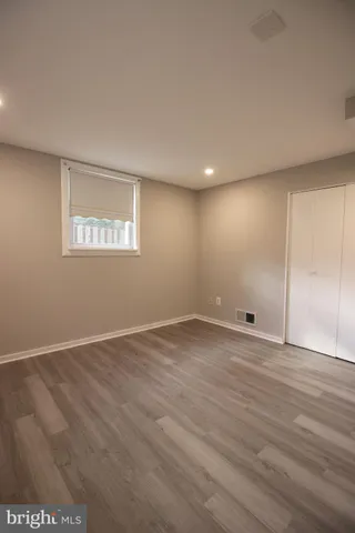 a view of a yard with large tree and wooden fence