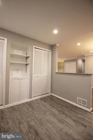 a kitchen with granite countertop a refrigerator stove top oven and sink