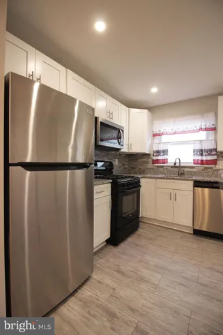 a view of room with wooden floor
