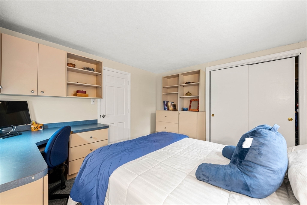 45 Wildwood Road Andover, MA 01810 - Photo 19 of 31 a bedroom with a bed and a book shelf