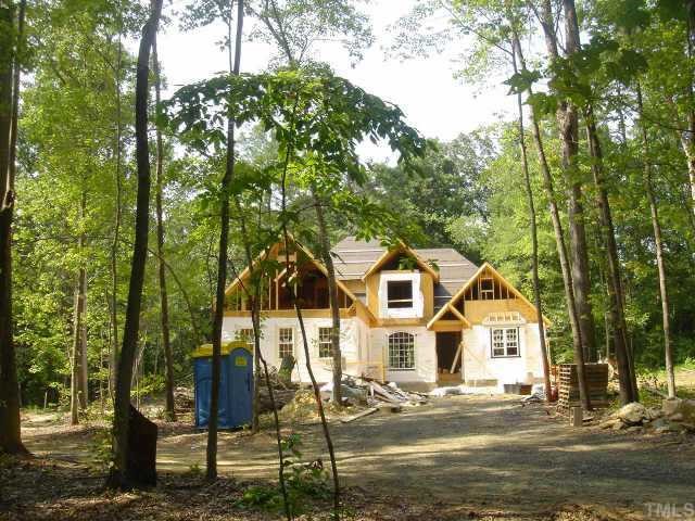 6003 Guess Road Durham, NC 27712 - Photo 1 of 1 a view of a white house next to a road and trees