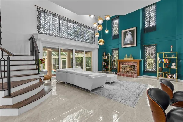 a living room with furniture and a book shelf