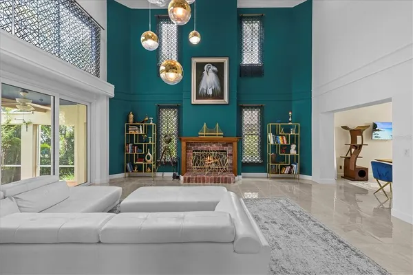 a living room with furniture and a floor to ceiling window