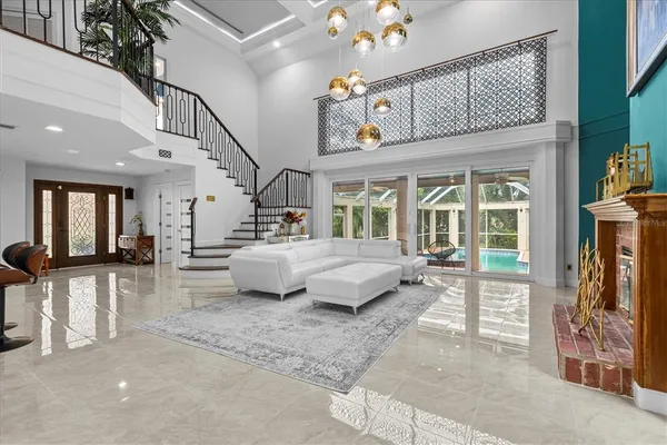 a living room with furniture and a chandelier