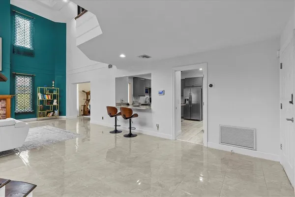 a kitchen with stainless steel appliances kitchen island granite countertop a sink stove and refrigerator