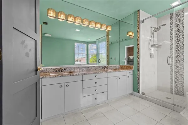 a bathroom with a bathtub vanity sink and mirror