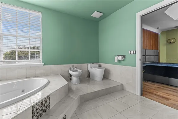 a very nice looking room with a large window and furniture