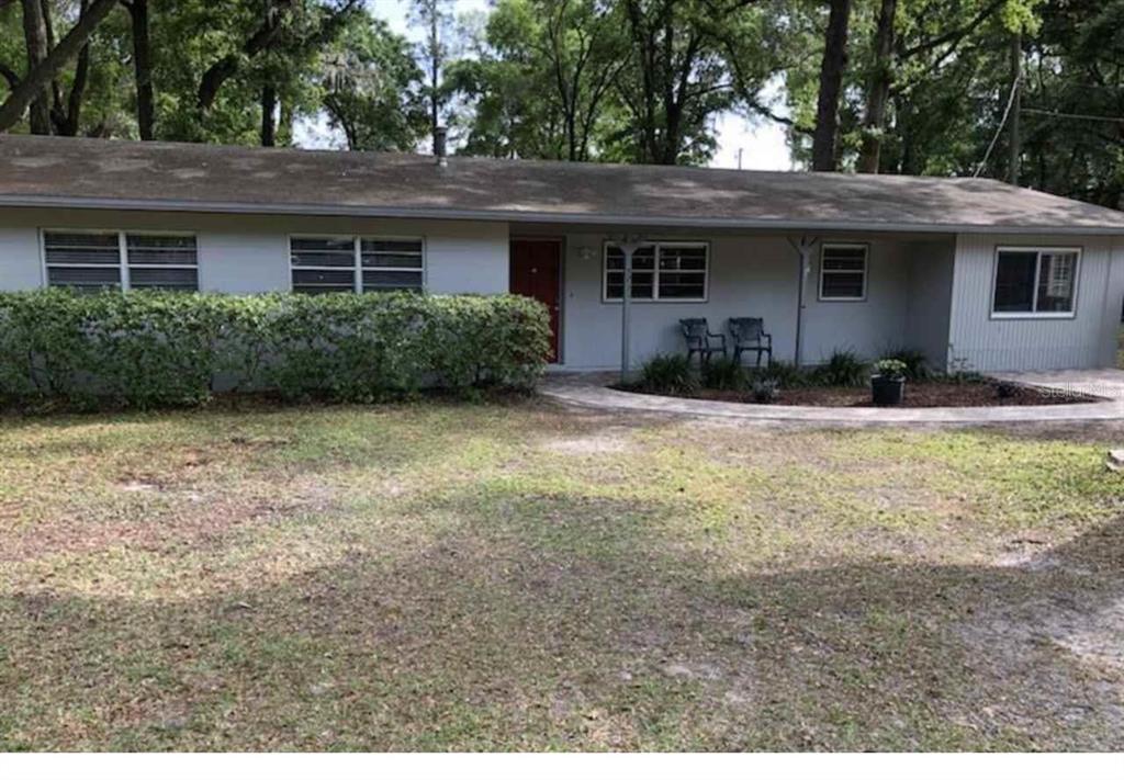 5231 Northwest 4 Place Gainesville, FL 32607 - Photo 1 of 1 a backyard of a house with yard and outdoor seating