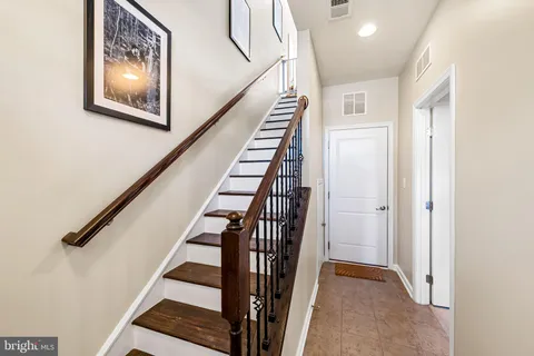 a view of a hallway with wooden floor and entryway