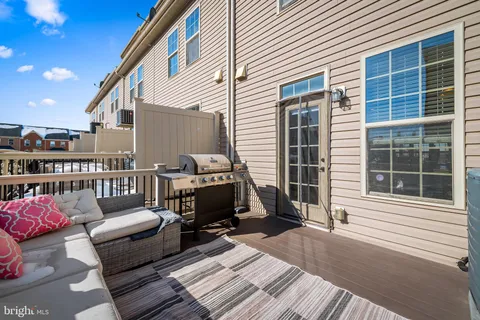 a view of a deck with couches chairs with wooden floor
