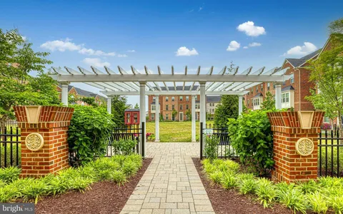 a view of a pathway with a flower garden