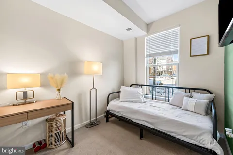 a bedroom with bed and a window