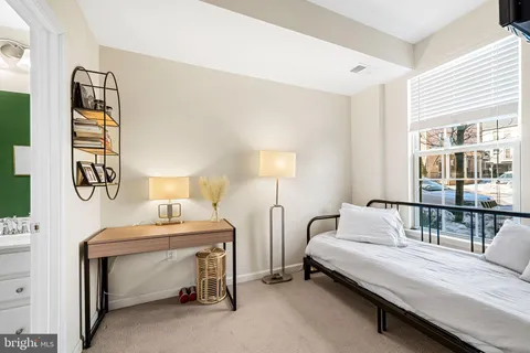 a bedroom with a bed and a table in it