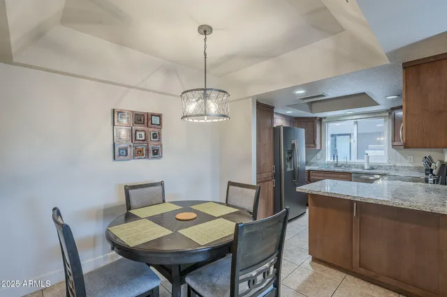 a view of a dining room with furniture a chandelier and wooden floor