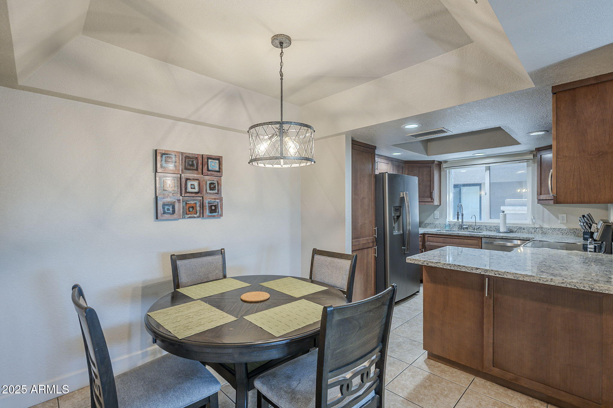 1905 East University Drive, Unit 131 Tempe, AZ 85288 - Photo 14 of 36 a view of a dining room with furniture a chandelier and wooden floor