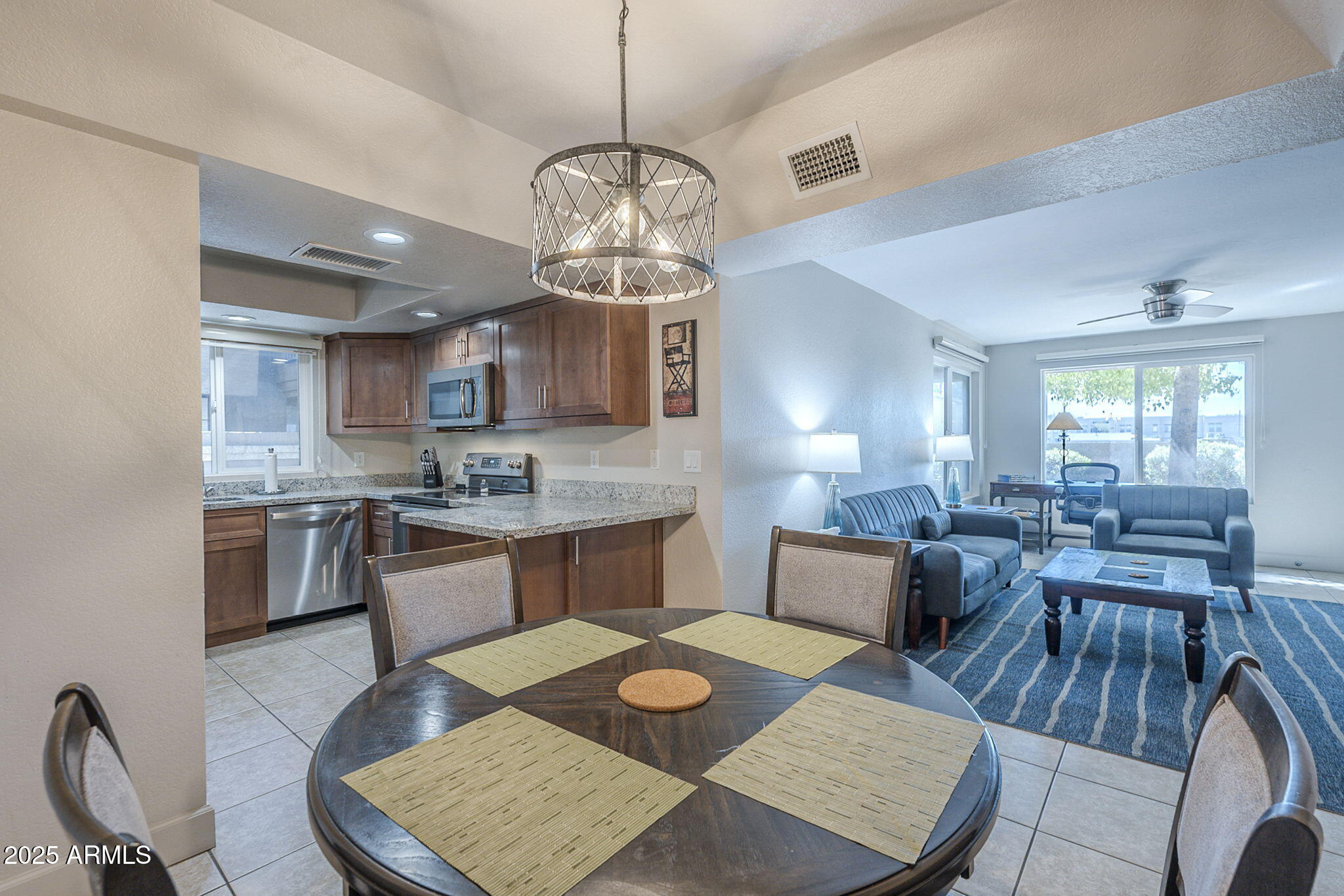 1905 East University Drive, Unit 131 Tempe, AZ 85288 - Photo 15 of 36 a large kitchen with a table and chairs