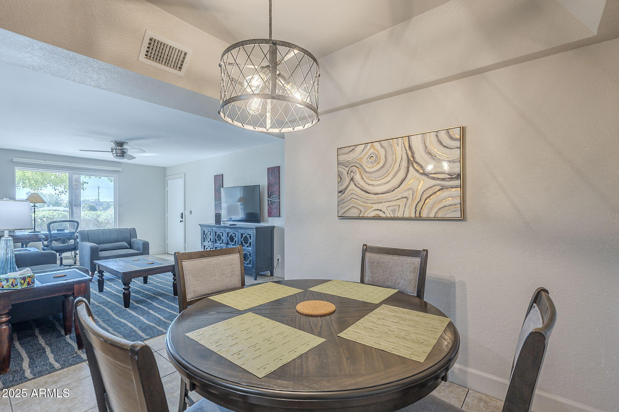 1905 East University Drive, Unit 131 Tempe, AZ 85288 - Photo 16 of 36 a view of a dining room with furniture wooden floor and chandelier