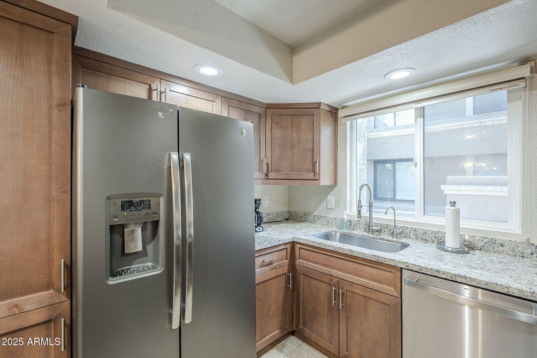 1905 East University Drive, Unit 131 Tempe, AZ 85288 - Photo 20 of 36 a kitchen with stainless steel appliances granite countertop a refrigerator and a sink
