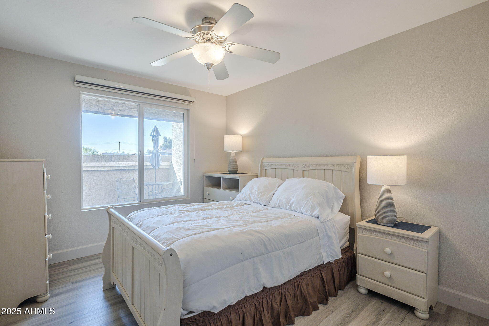 1905 East University Drive, Unit 131 Tempe, AZ 85288 - Photo 21 of 36 a bedroom with a bed and a chandelier