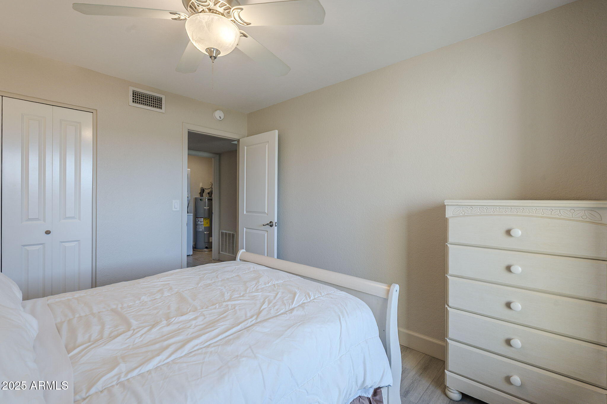 1905 East University Drive, Unit 131 Tempe, AZ 85288 - Photo 22 of 36 a bedroom with a bed and a dresser