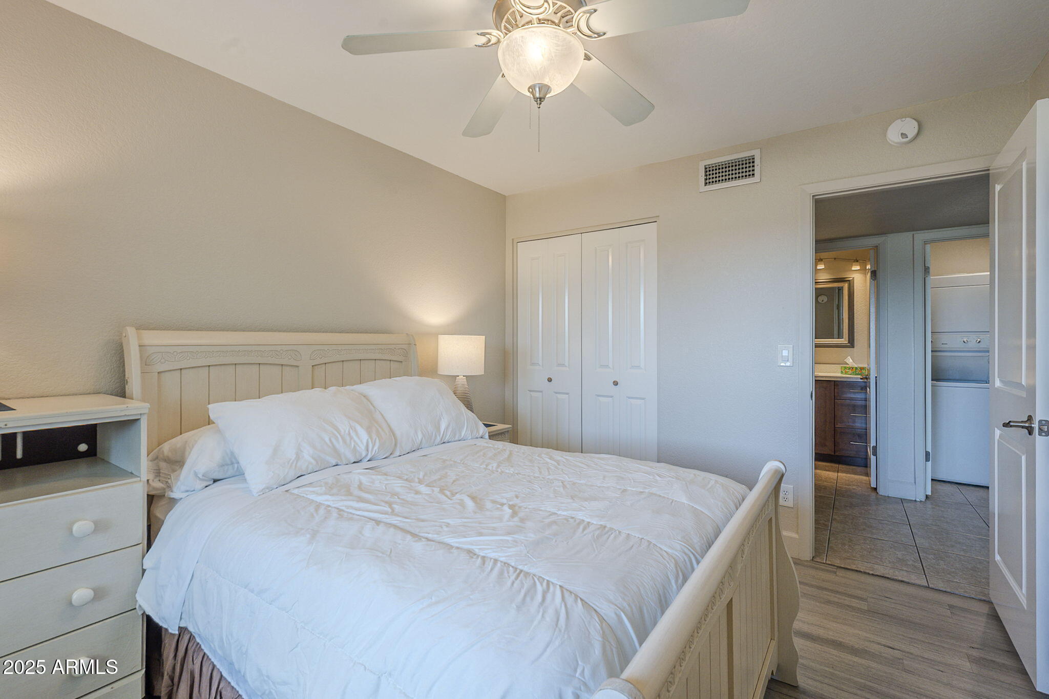 1905 East University Drive, Unit 131 Tempe, AZ 85288 - Photo 23 of 36 a bedroom with a bed and a chandelier