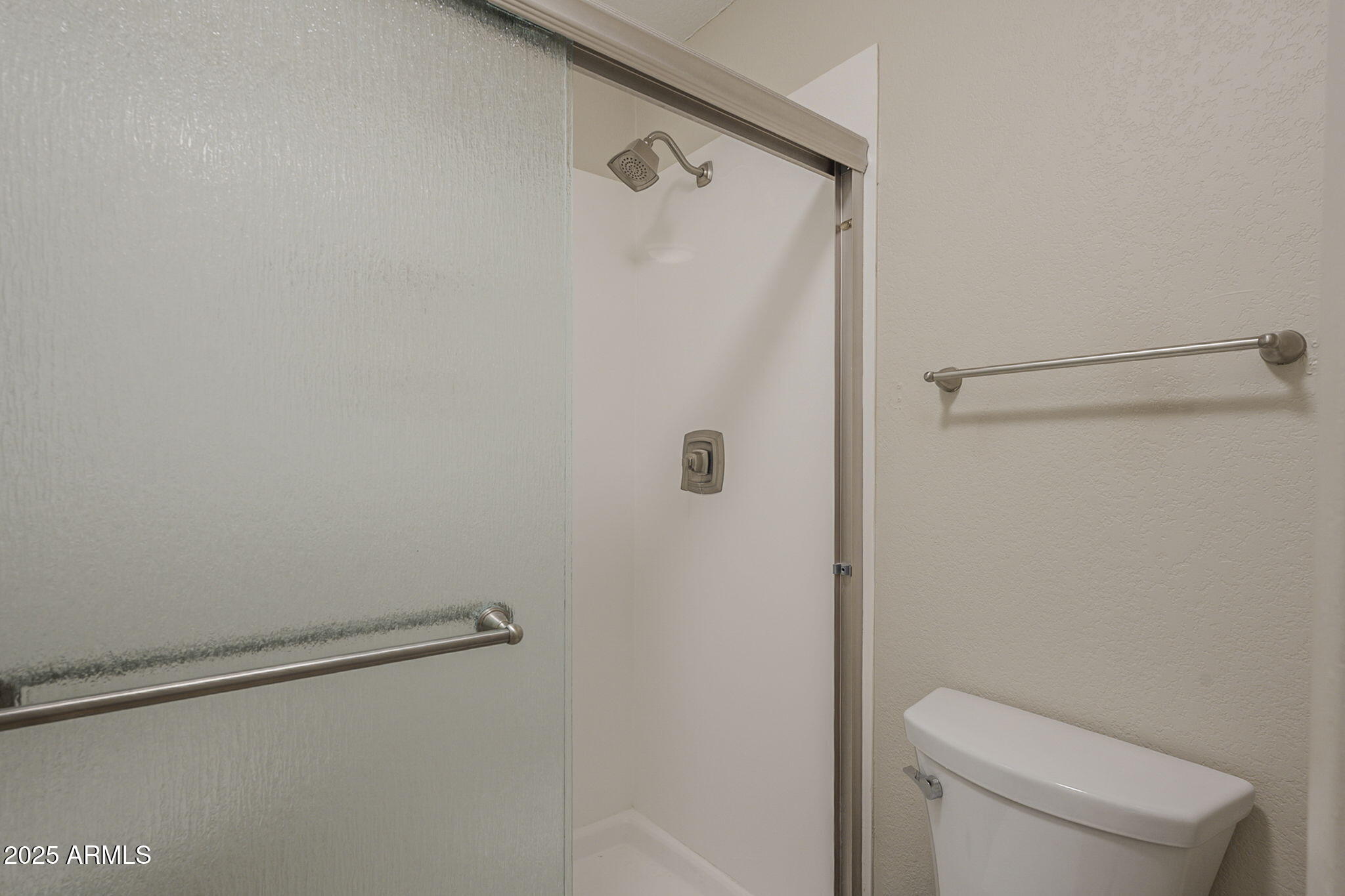1905 East University Drive, Unit 131 Tempe, AZ 85288 - Photo 25 of 36 a bathroom with a shower and toilet