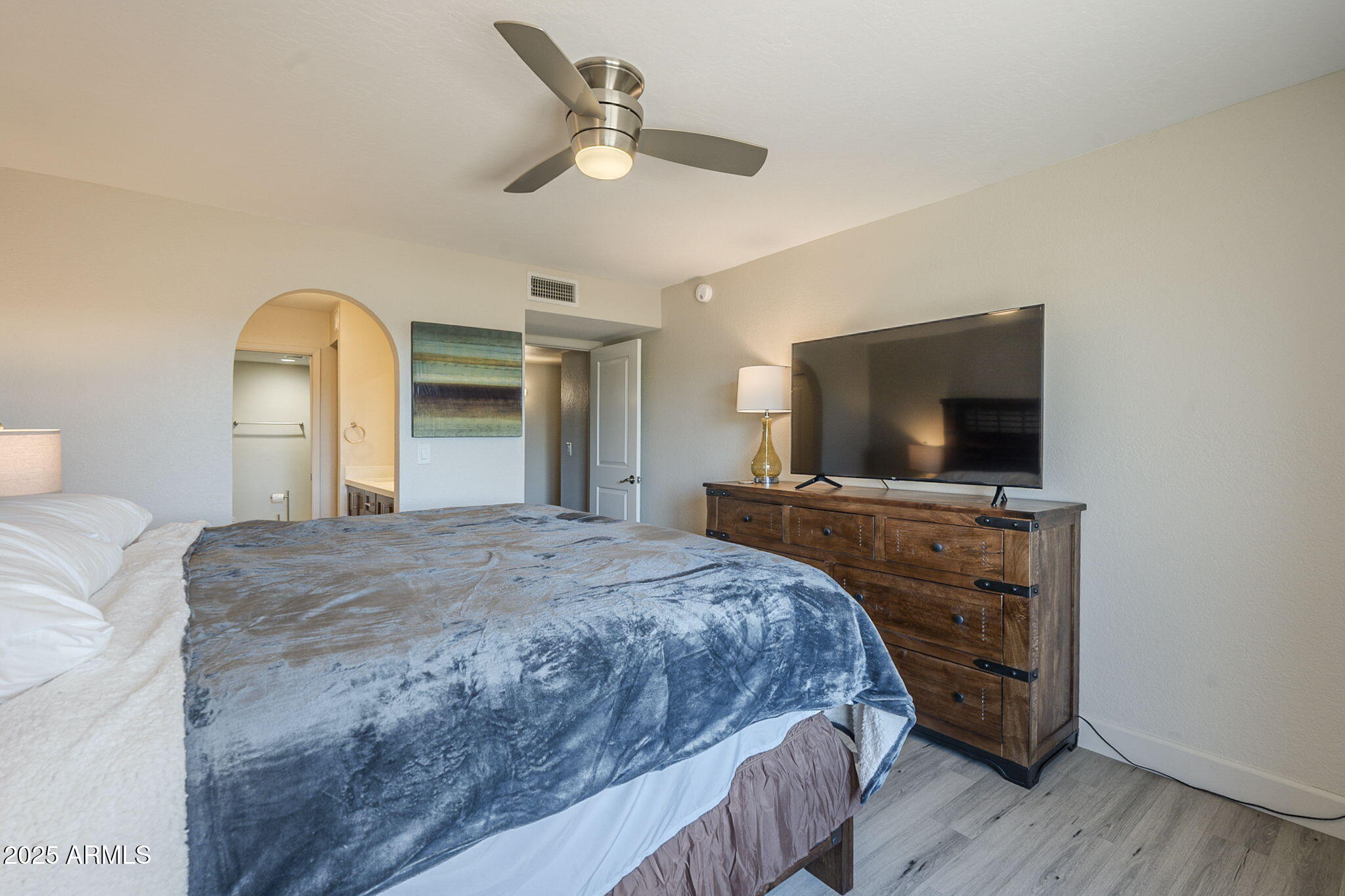 1905 East University Drive, Unit 131 Tempe, AZ 85288 - Photo 28 of 36 a bedroom with a bed and a flat screen tv