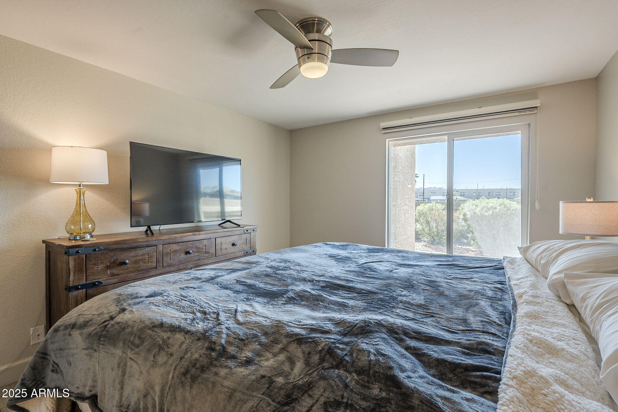 1905 East University Drive, Unit 131 Tempe, AZ 85288 - Photo 29 of 36 a bedroom with a bed and a chandelier