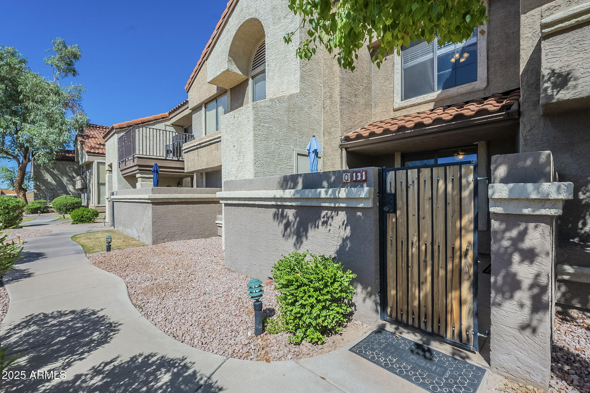 1905 East University Drive, Unit 131 Tempe, AZ 85288 - Photo 3 of 36 a front view of a house with garden
