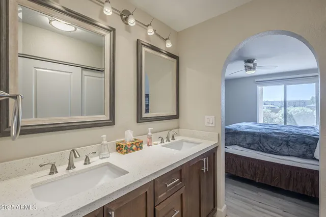 a en suite bathroom with a double vanity sink and a mirror
