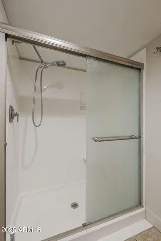 a bathroom with a glass shower door