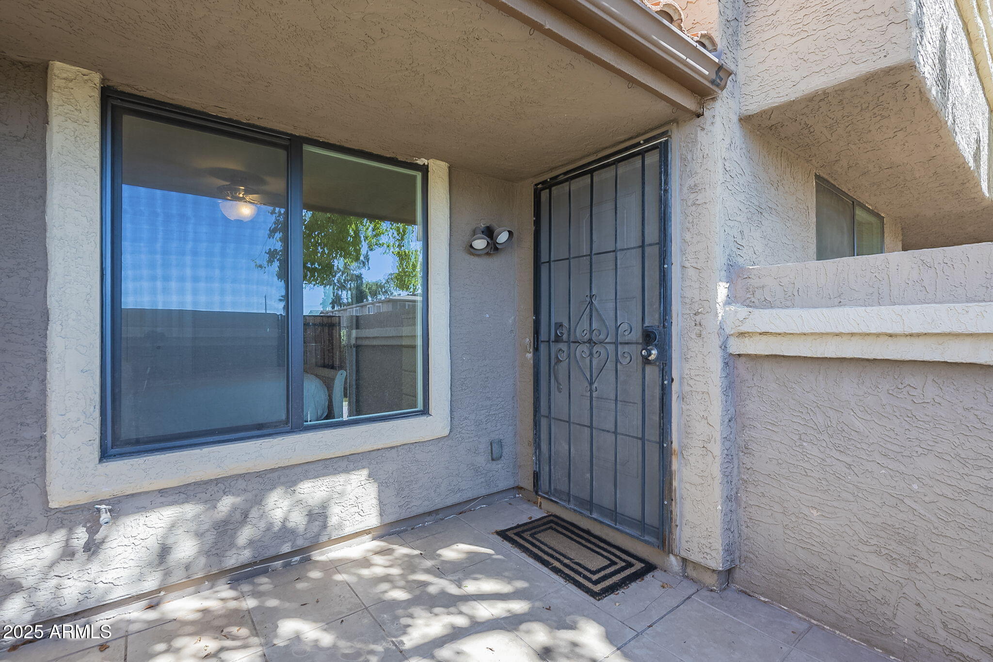 1905 East University Drive, Unit 131 Tempe, AZ 85288 - Photo 7 of 36 a view of a room that has a large window and front view of a house