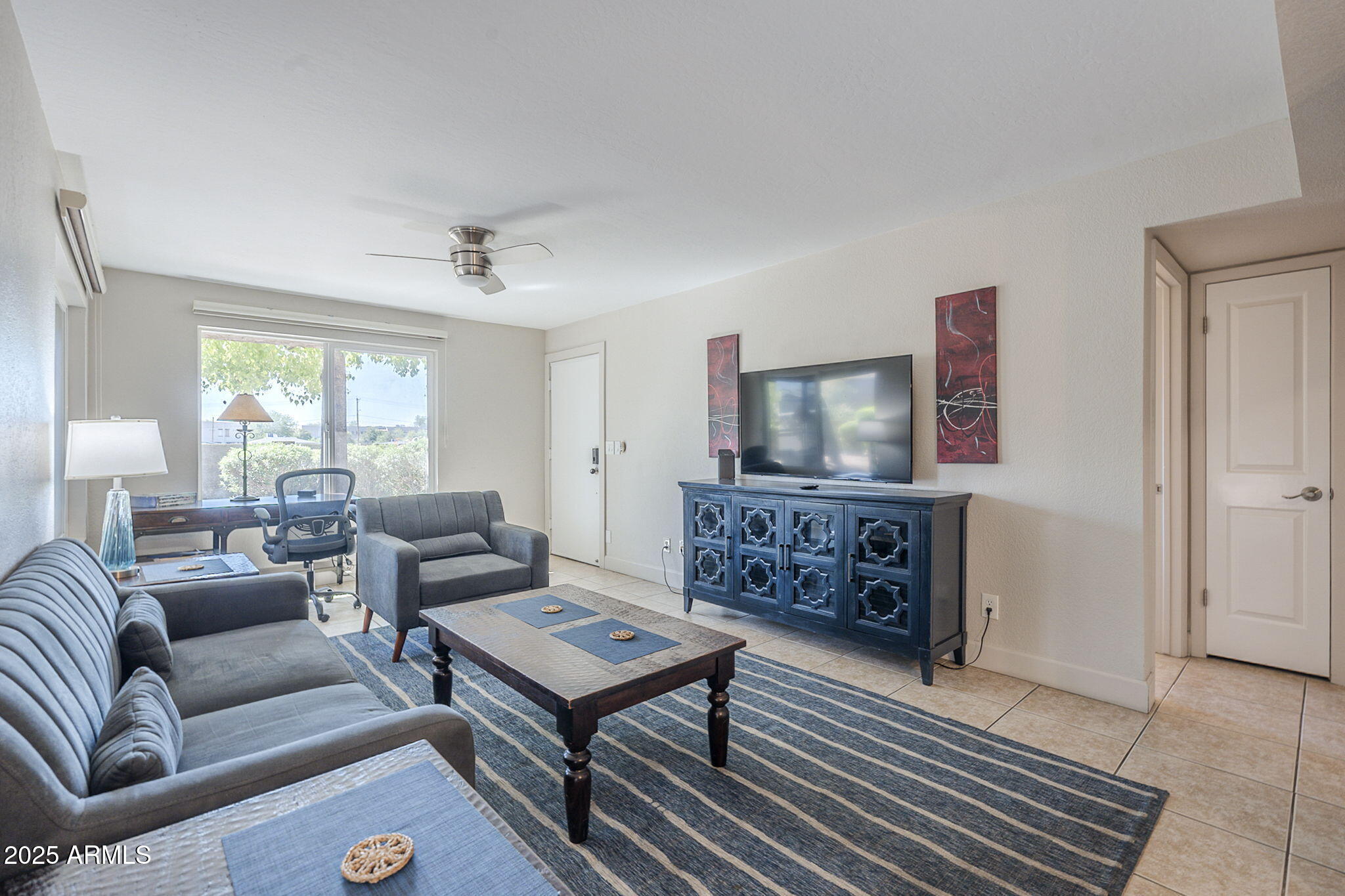 1905 East University Drive, Unit 131 Tempe, AZ 85288 - Photo 10 of 36 a living room with furniture and a flat screen tv
