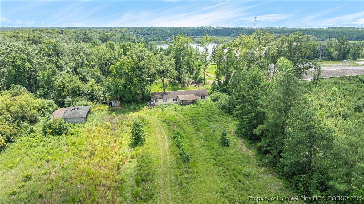 3402 Pine Log Road Lumberton, NC 28360 - Photo 13 of 24 a view of a garden with a building in the background