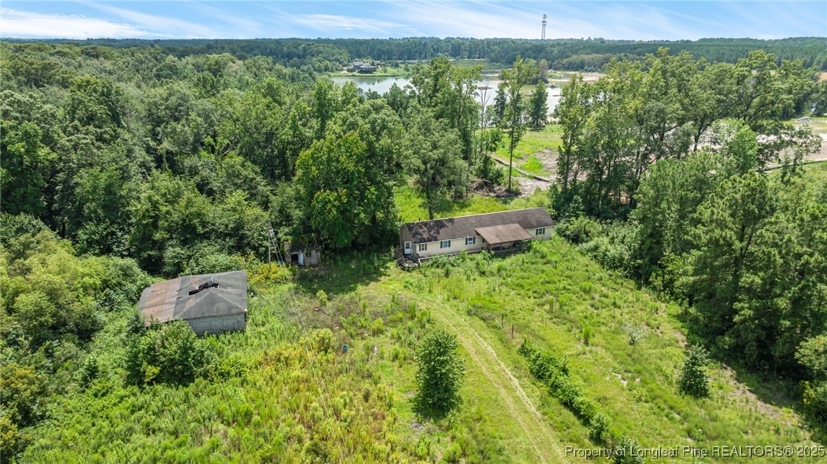 3402 Pine Log Road Lumberton, NC 28360 - Photo 18 of 24 a view of a garden with a building in the background