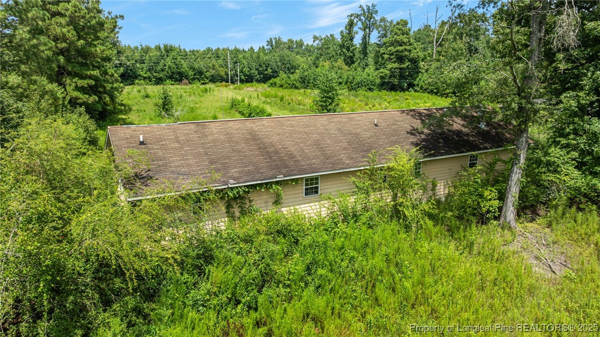 3402 Pine Log Road Lumberton, NC 28360 - Photo 19 of 24 a view of a garden with large trees