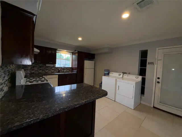 a kitchen with a sink stove and refrigerator