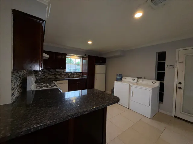 a kitchen with a sink and white cabinets
