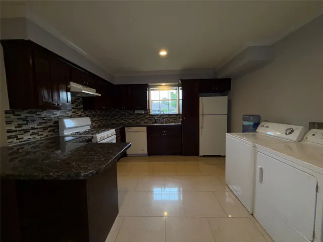 a kitchen with a sink and a stove top oven