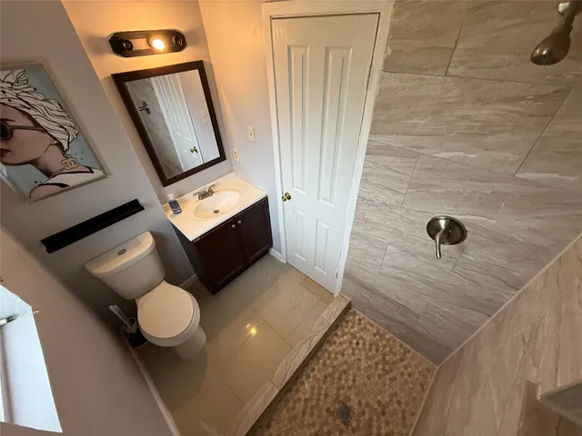 a bathroom with a toilet sink and mirror
