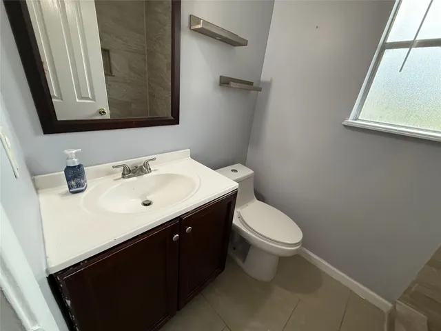 a bathroom with a sink toilet and mirror