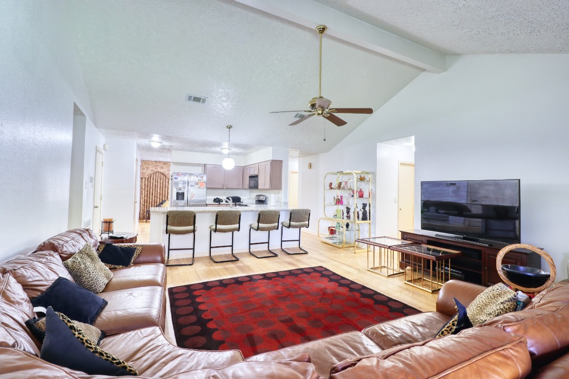 3446 Cheaney Drive Houston, TX 77066 - Photo 12 of 49 a living room with furniture a flat screen tv and kitchen view