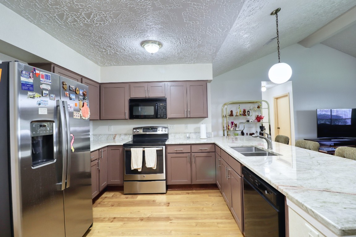 3446 Cheaney Drive Houston, TX 77066 - Photo 17 of 49 a kitchen with stainless steel appliances granite countertop a sink refrigerator and microwave
